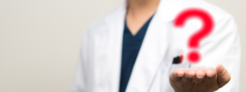 Question mark over doctor's hand