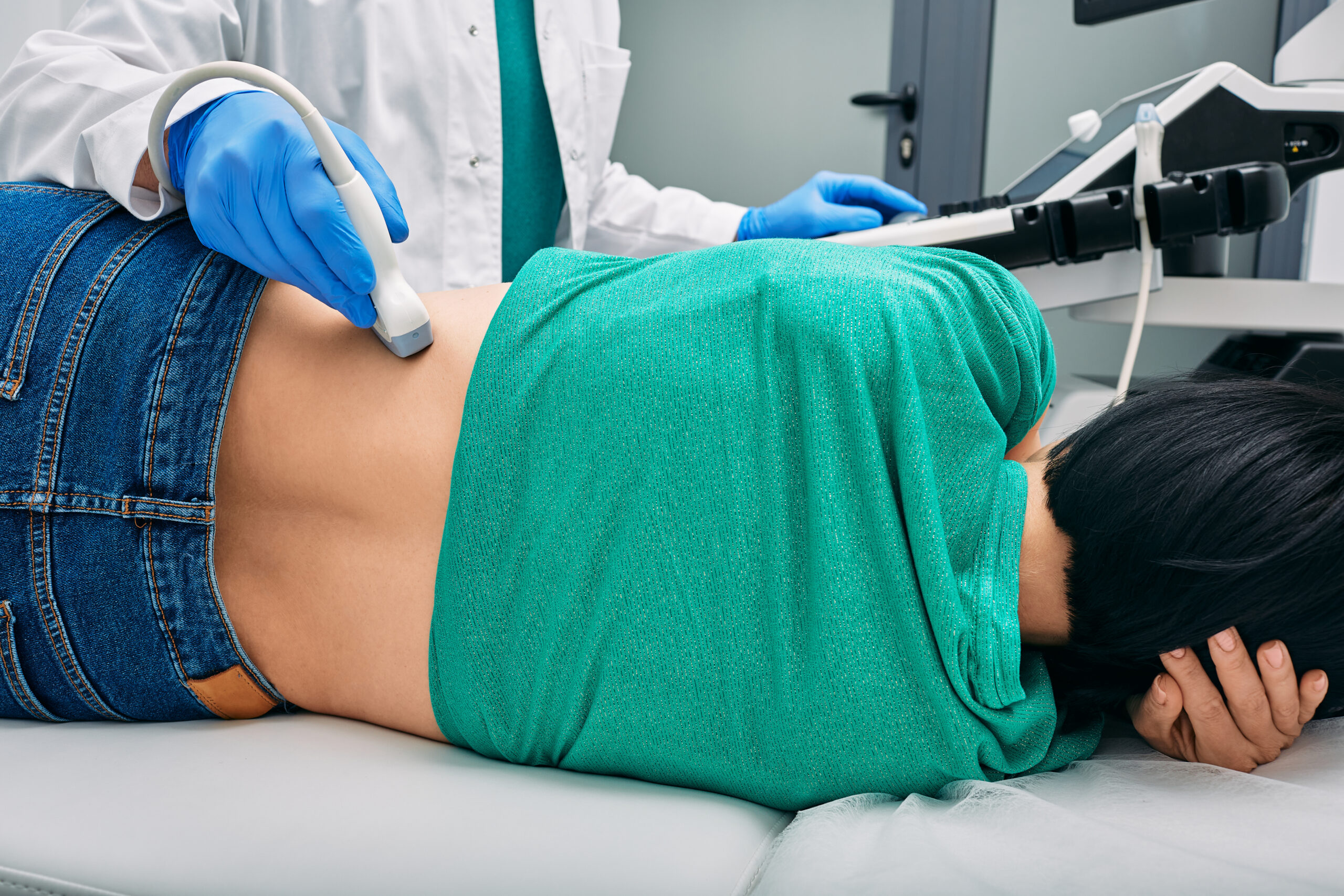 Woman receiving a kidney ultrasound in a doctor's office