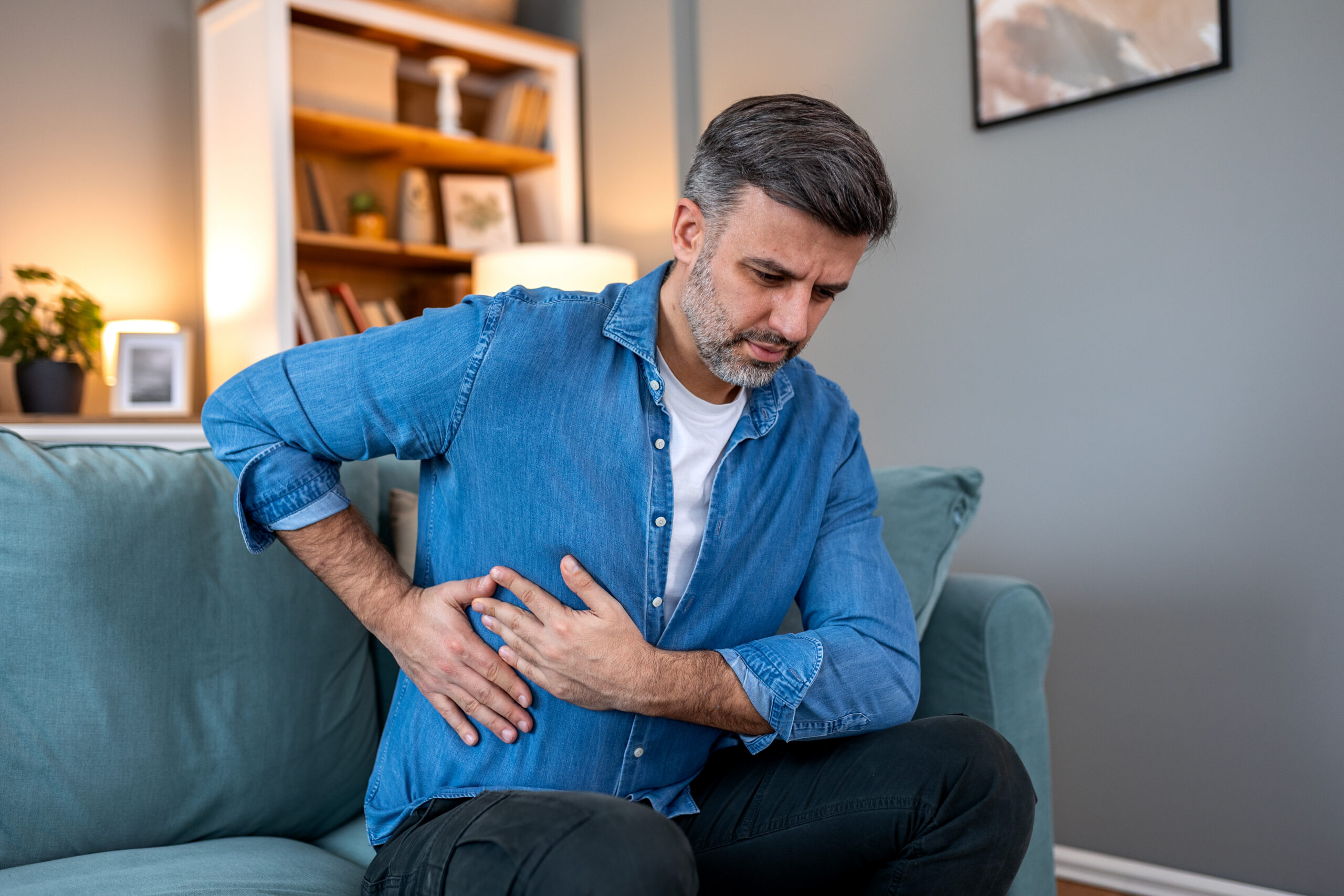 Middle aged man experiencing pain in his side