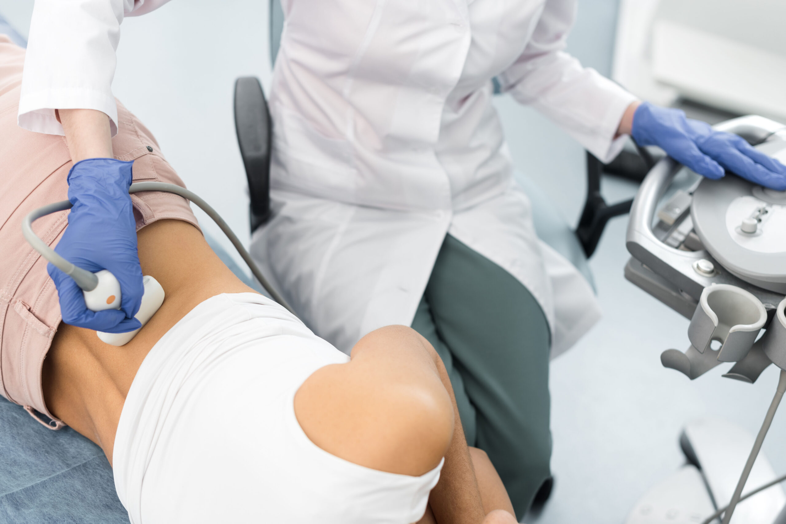 Cropped view of doctor examining kidney of patient with ultrasound scan in clinic